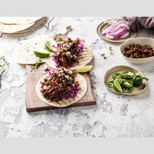 Load image into Gallery viewer, Five Vegans Fable pulled shiitake mushroom tacos served on a wooden board with lime, red cabbage, and jalapeños.